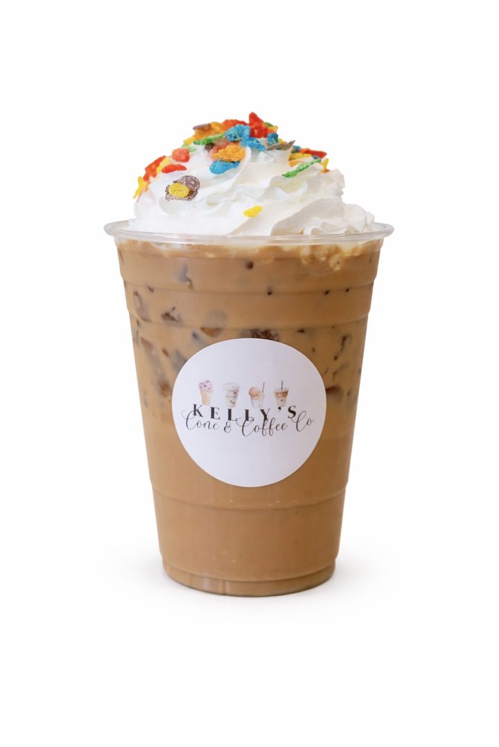 Iced coffee topped with whipped cream and sprinkles